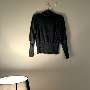 a lightly loved teal sweater w/ out tags / hinges @ the forearms